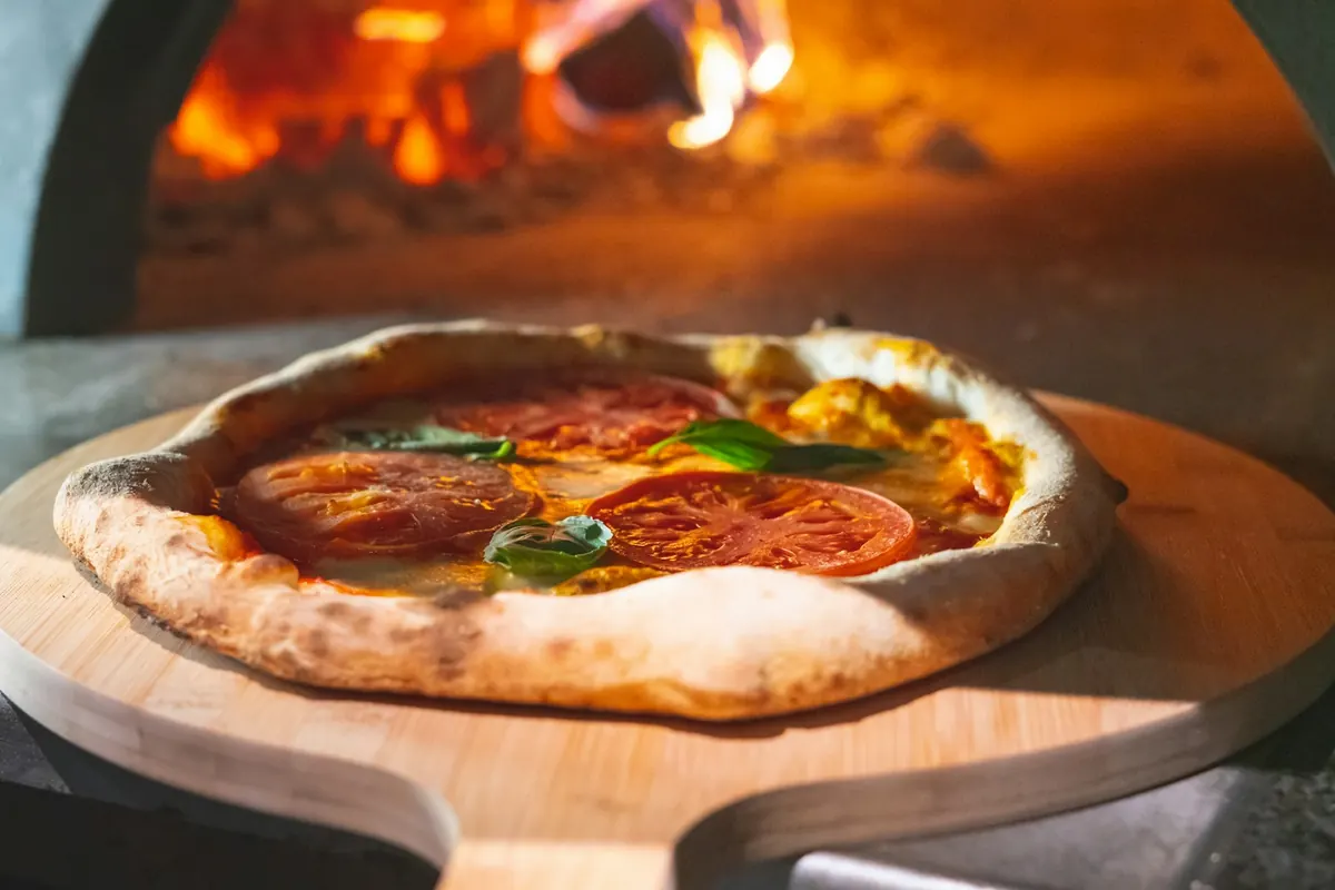 Pizza casera de masa madre horneada en un horno de leña